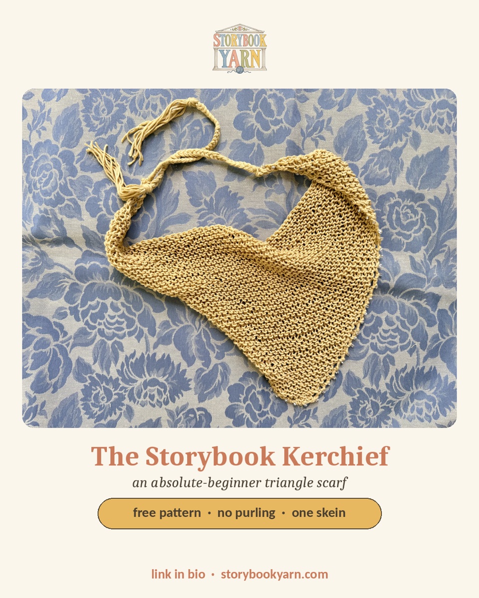 The Storybook Kerchief — a small yellow knit triangle scarf folded on a blue floral backdrop.